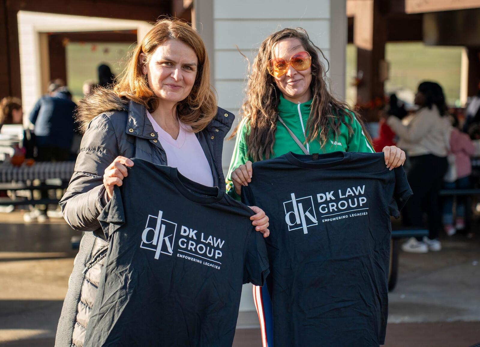 Guests holding up DK Law Group t-shirts